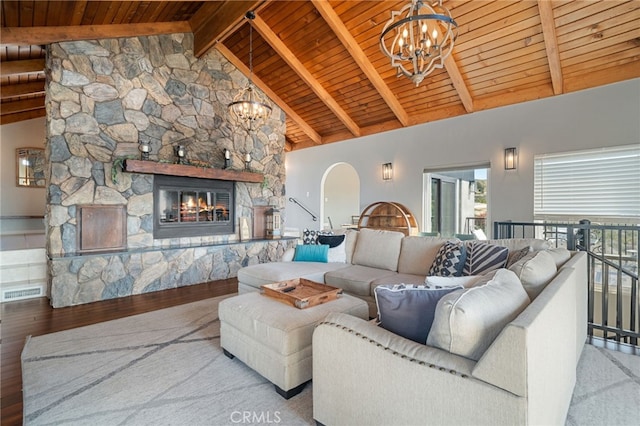 living area featuring wood finished floors, a fireplace, wood ceiling, beamed ceiling, and a chandelier