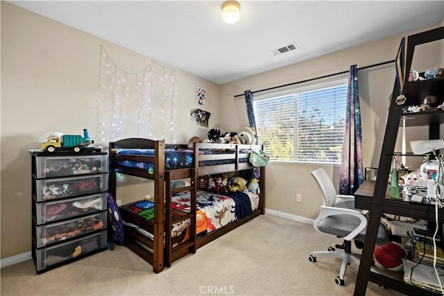 bedroom featuring baseboards, visible vents, and light colored carpet