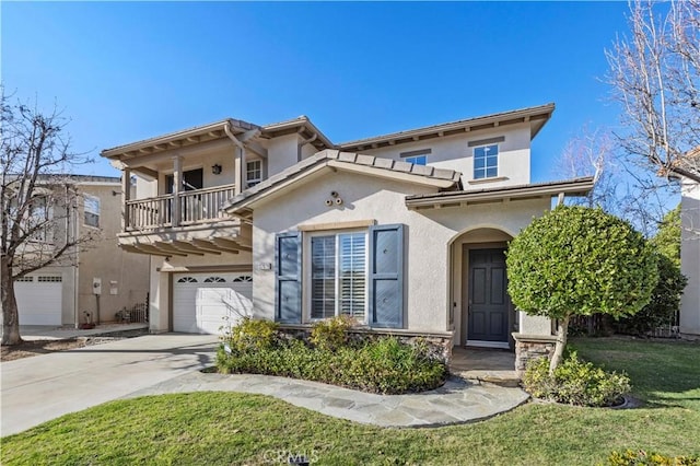 mediterranean / spanish-style house featuring a garage, concrete driveway, a balcony, stucco siding, and a front yard