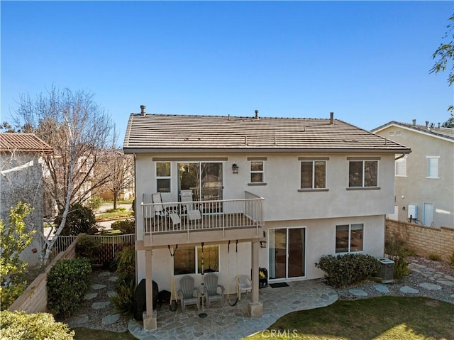 rear view of property featuring a patio, central air condition unit, fence, and stucco siding