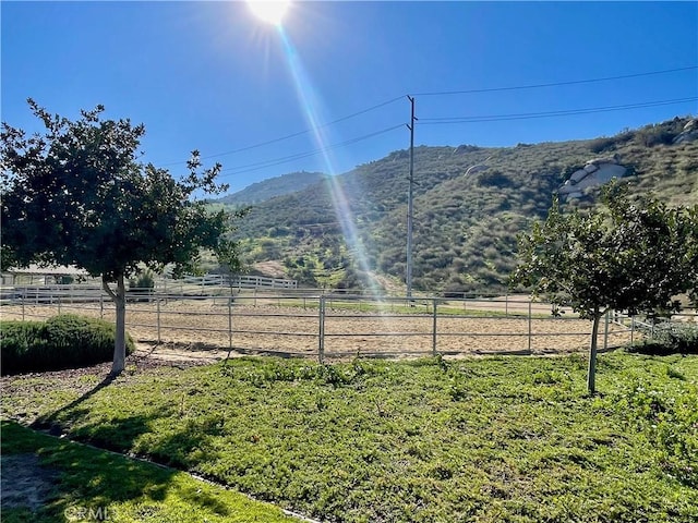 view of yard with a mountain view, a rural view, and fence