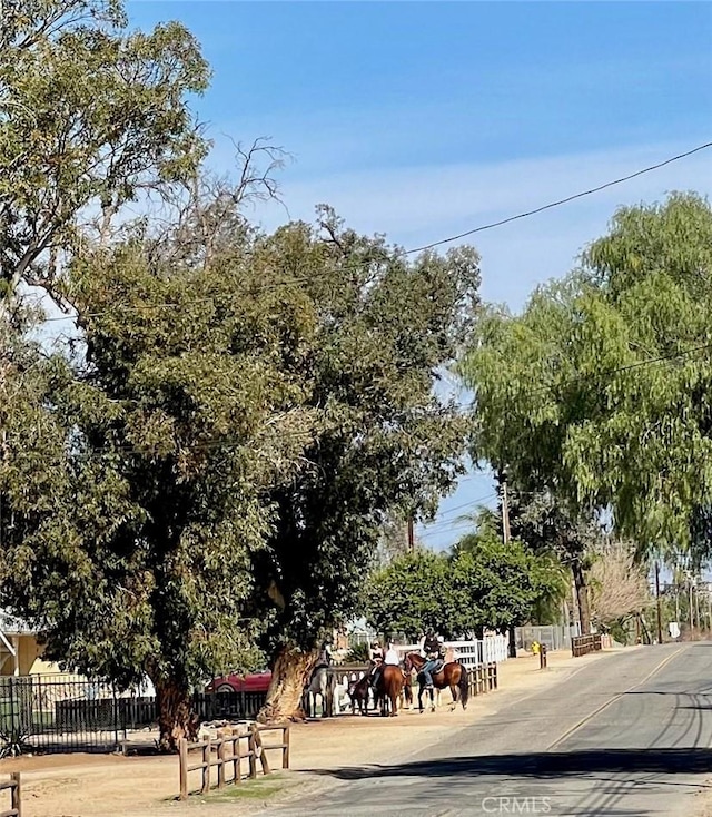 view of home's community featuring fence