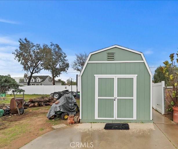 view of shed featuring fence