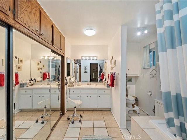 bathroom featuring tile patterned floors, toilet, a shower with shower curtain, and vanity