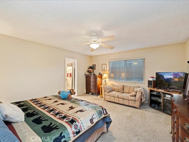 bedroom featuring ceiling fan, a textured ceiling, and carpet