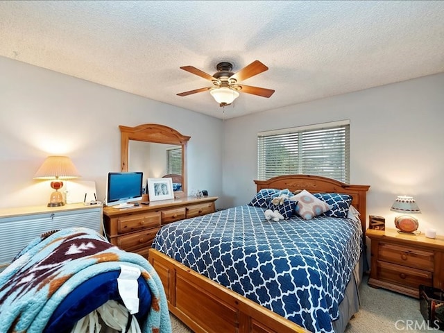 bedroom with light carpet, a textured ceiling, and ceiling fan