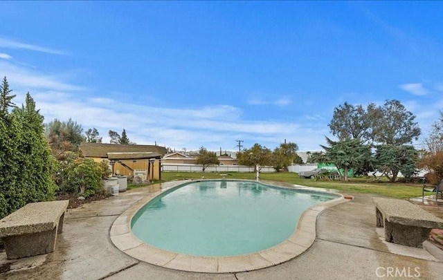 view of pool featuring a yard, a fenced in pool, and a patio