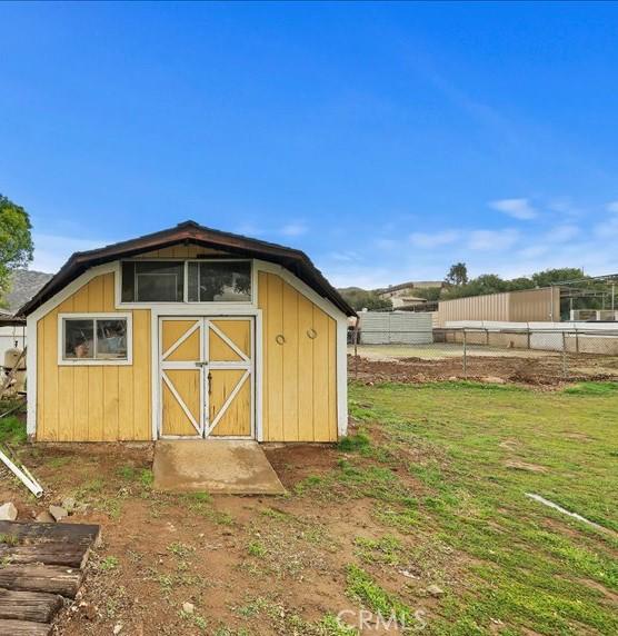 view of shed with fence