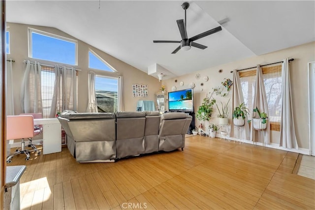 living area featuring lofted ceiling, ceiling fan, and wood finished floors