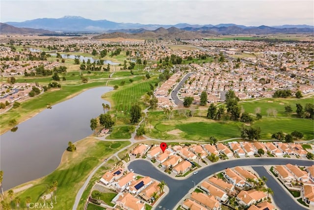 aerial view featuring golf course view, a residential view, and a water and mountain view