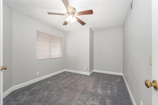 spare room with baseboards, visible vents, dark colored carpet, and a textured ceiling