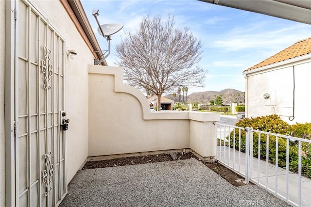 view of patio featuring fence and a mountain view