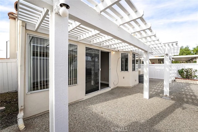 view of patio featuring fence and a pergola