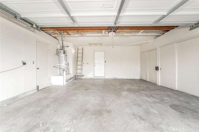 garage featuring a garage door opener and secured water heater