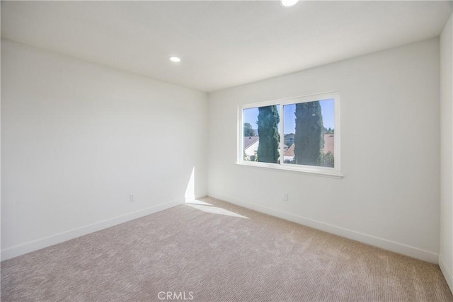 unfurnished room with carpet, baseboards, and recessed lighting