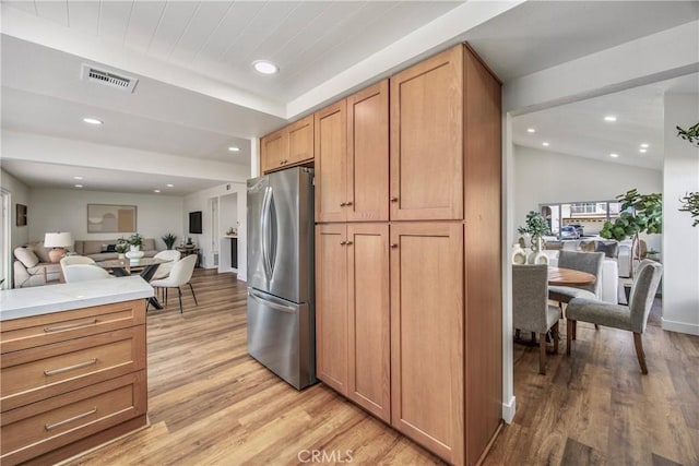 kitchen featuring visible vents, light wood-style flooring, open floor plan, freestanding refrigerator, and recessed lighting