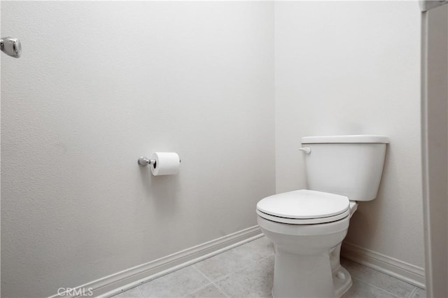 bathroom featuring baseboards, toilet, and tile patterned floors