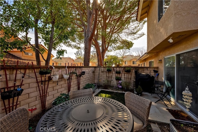 view of patio with outdoor dining space and a fenced backyard