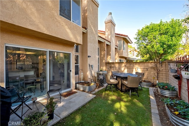 view of yard with central air condition unit, a patio area, and fence