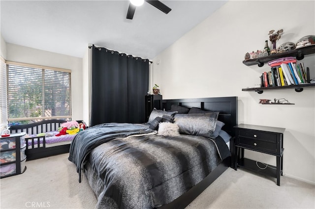 bedroom featuring vaulted ceiling, a ceiling fan, and light colored carpet