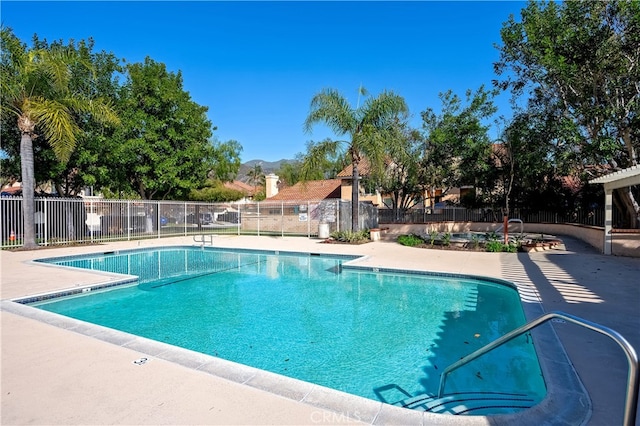 pool featuring a patio and fence