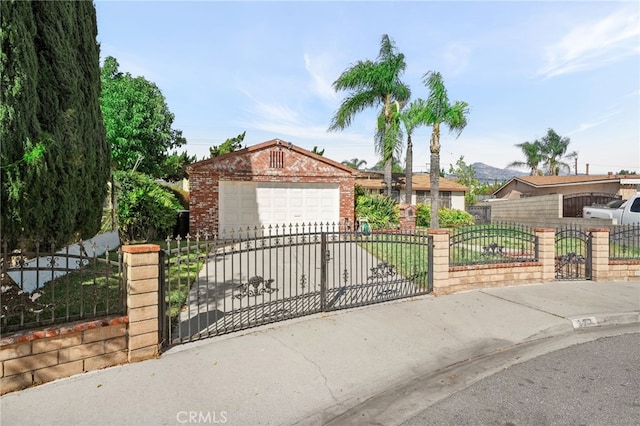 single story home featuring a gate, concrete driveway, a garage, a fenced front yard, and brick siding