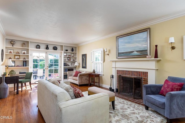 living room with a fireplace, ornamental molding, wood finished floors, and french doors