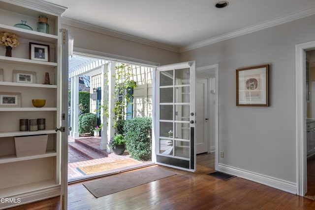 entryway with baseboards, visible vents, ornamental molding, and dark wood-style flooring