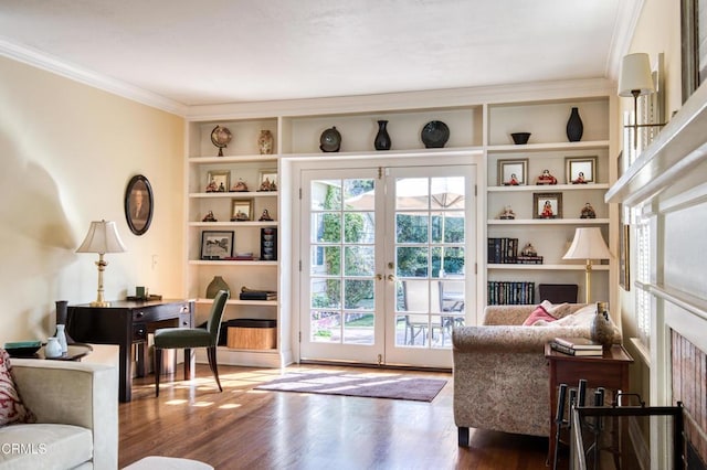 interior space with built in shelves, ornamental molding, wood finished floors, and french doors