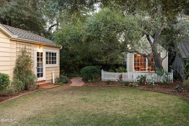 view of yard with fence and an outbuilding