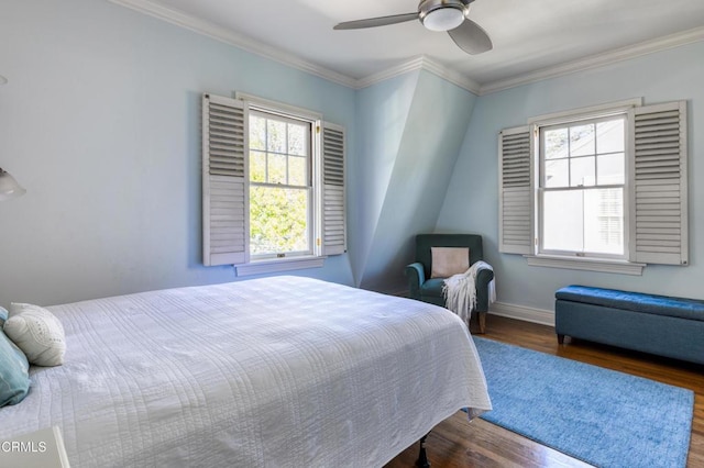 bedroom featuring dark wood-type flooring, crown molding, baseboards, and a ceiling fan