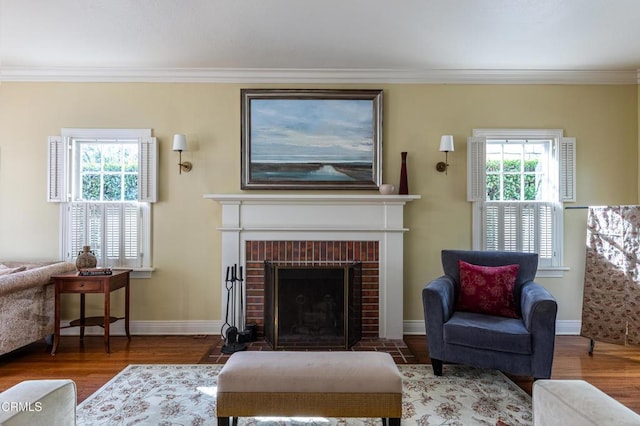 sitting room with crown molding and wood finished floors