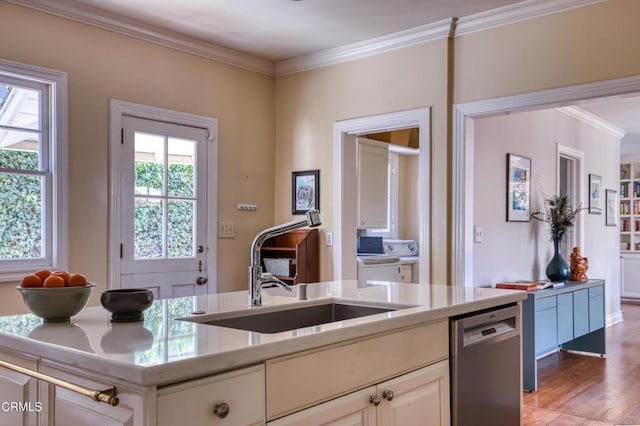 kitchen featuring crown molding, light countertops, stainless steel dishwasher, white cabinetry, and a sink