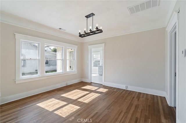 unfurnished dining area with visible vents, a notable chandelier, dark wood-style floors, and crown molding