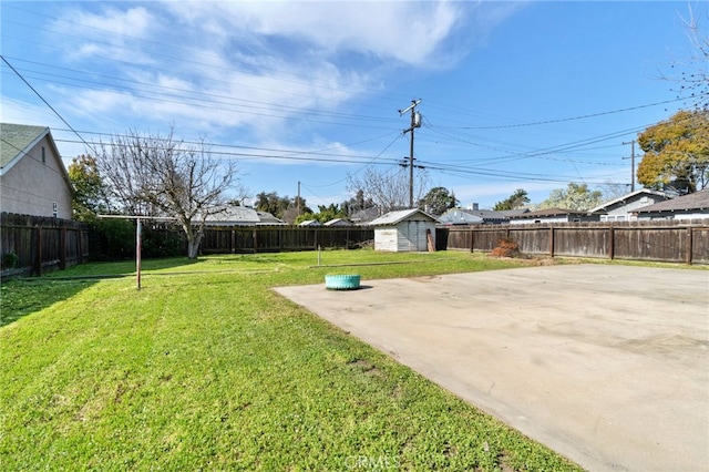 view of yard with a storage shed, an outbuilding, a fenced backyard, and a patio