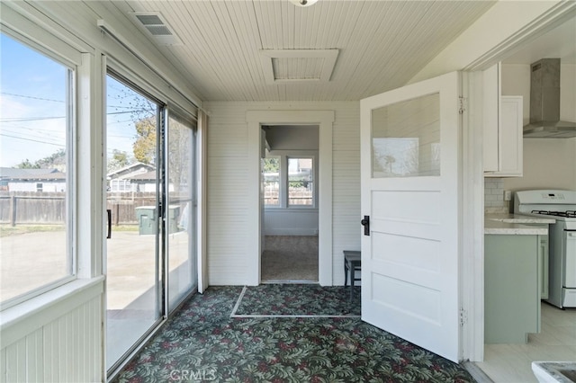 unfurnished sunroom with visible vents