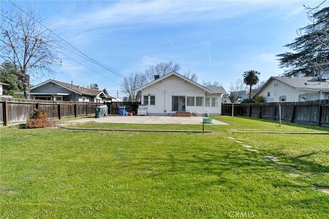 back of property featuring a patio, a lawn, and a fenced backyard