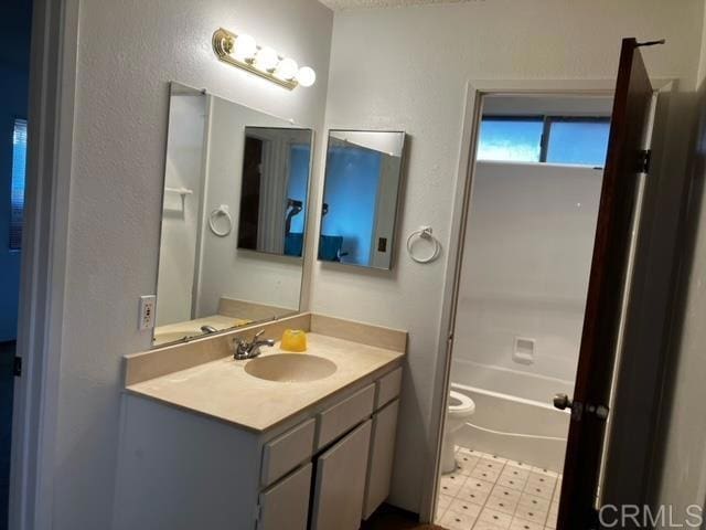 bathroom featuring toilet, tile patterned floors, and vanity