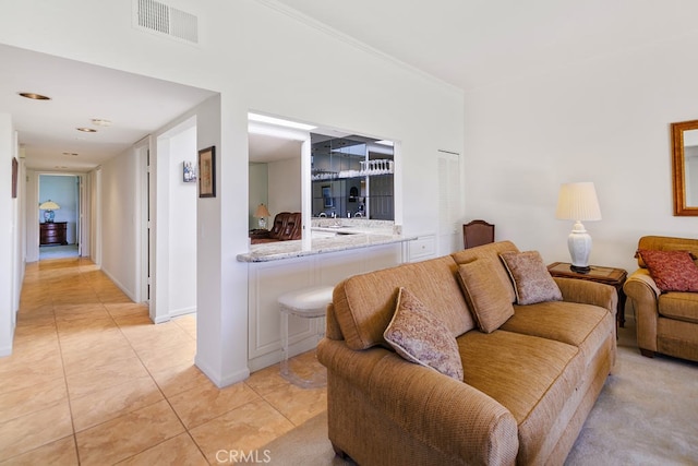 living room with light tile patterned flooring and visible vents