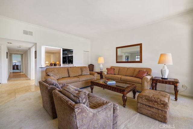 living room featuring light tile patterned flooring, visible vents, and light colored carpet