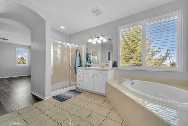 full bathroom featuring visible vents, vanity, a shower stall, tile patterned flooring, and a bath