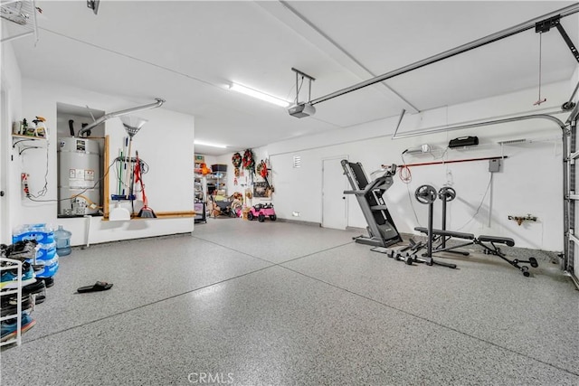 garage featuring strapped water heater and a garage door opener