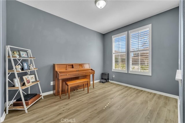 living area featuring baseboards and wood finished floors