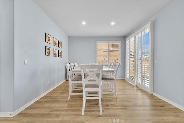 dining space with light wood-style floors, baseboards, and recessed lighting