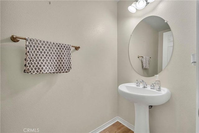 bathroom featuring baseboards and wood finished floors