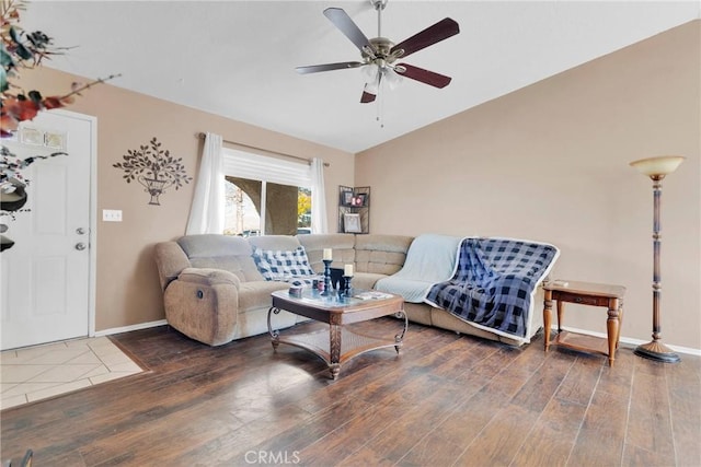 living room featuring lofted ceiling, ceiling fan, wood finished floors, and baseboards