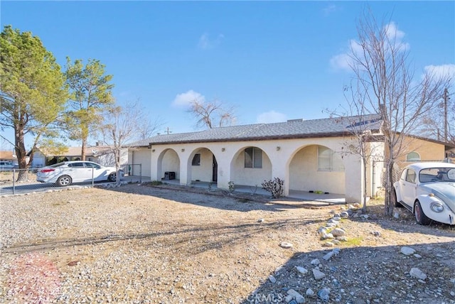 view of front of property with a porch and stucco siding