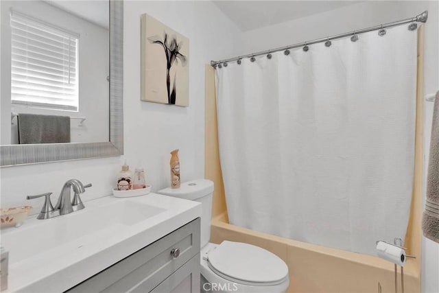 bathroom with vanity, toilet, and shower / bath combo with shower curtain