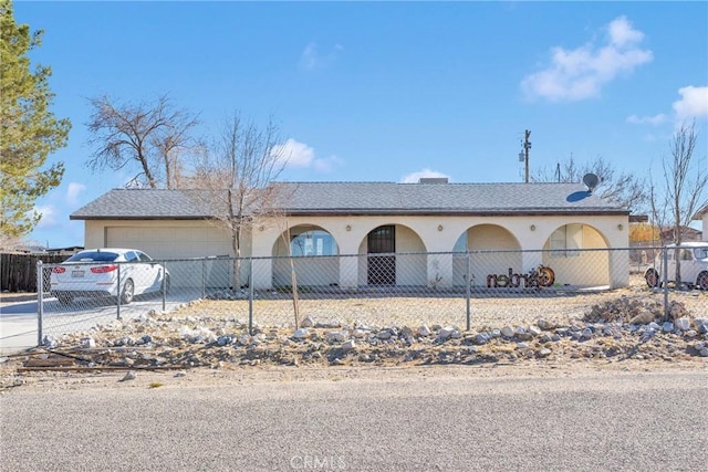 view of front of house featuring a garage, concrete driveway, and stucco siding