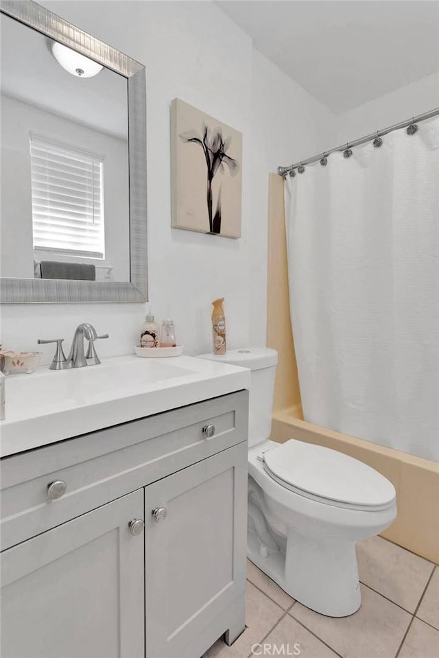 bathroom featuring toilet, tile patterned flooring, shower / bath combo, and vanity